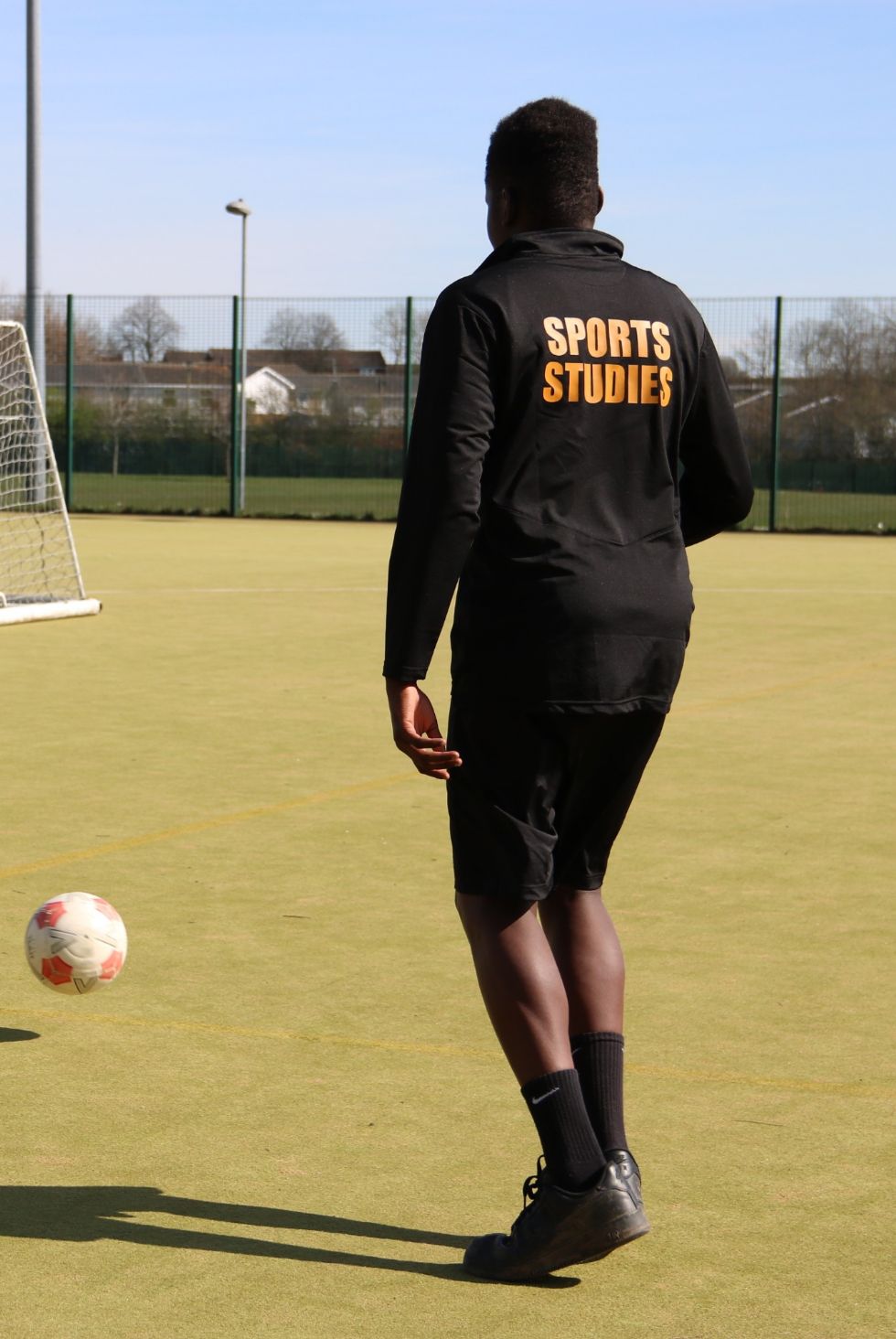 boy wearing a sports top saying sports studies