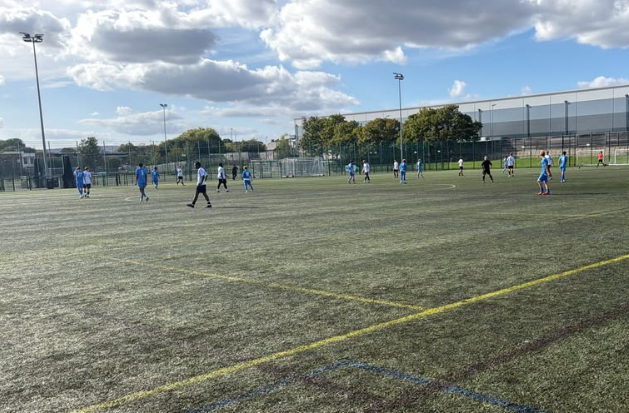 football players on the pitch, seen in the distance
