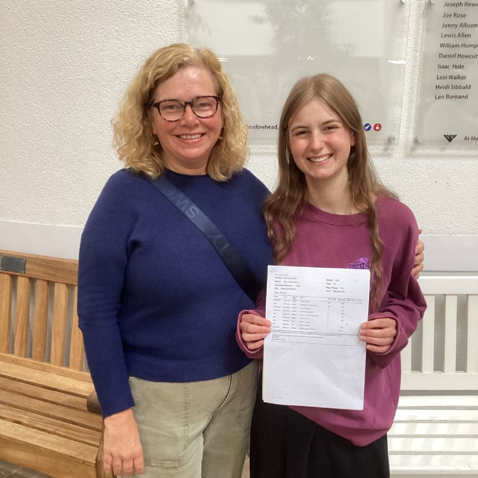 Y11 student with parent receive their GCSE results in the school Rosling