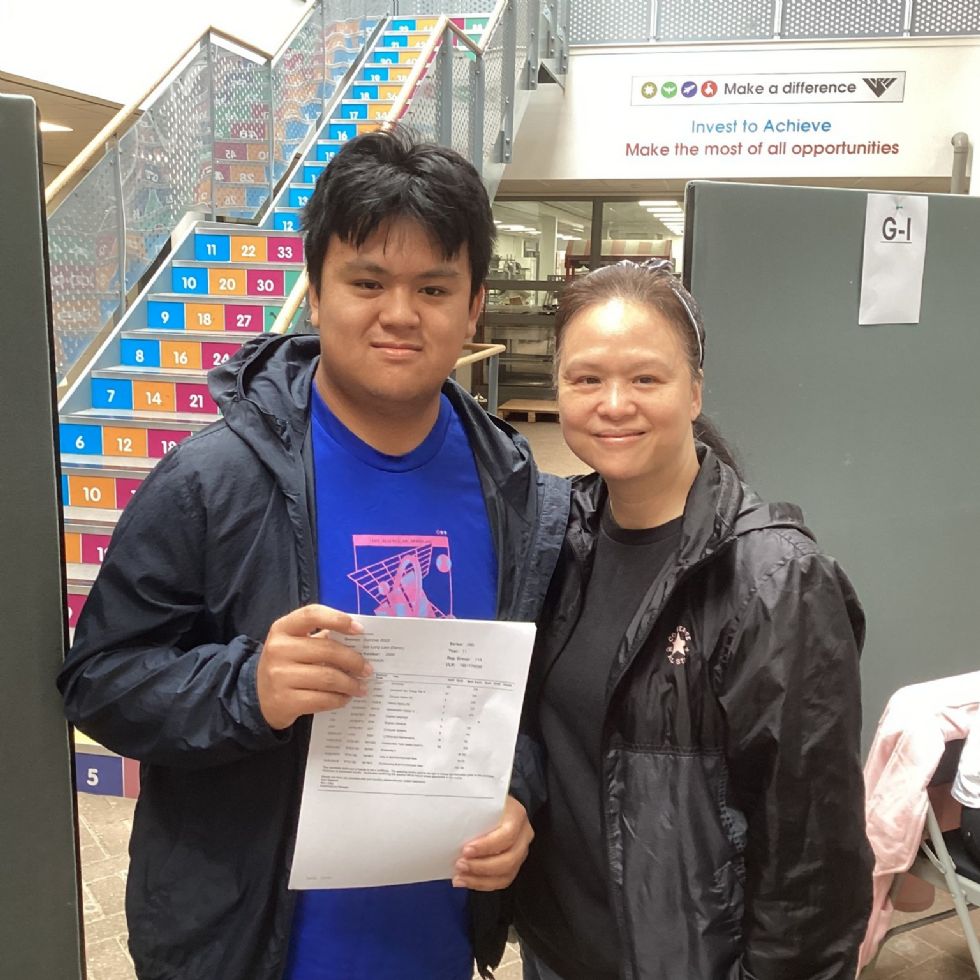 Y11 student with parent receive their GCSE results in the school Rosling