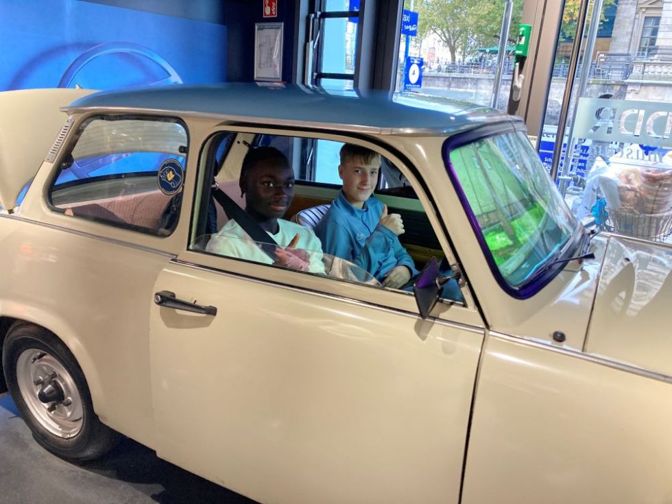 students sitting in an old car at a museum in Berlin