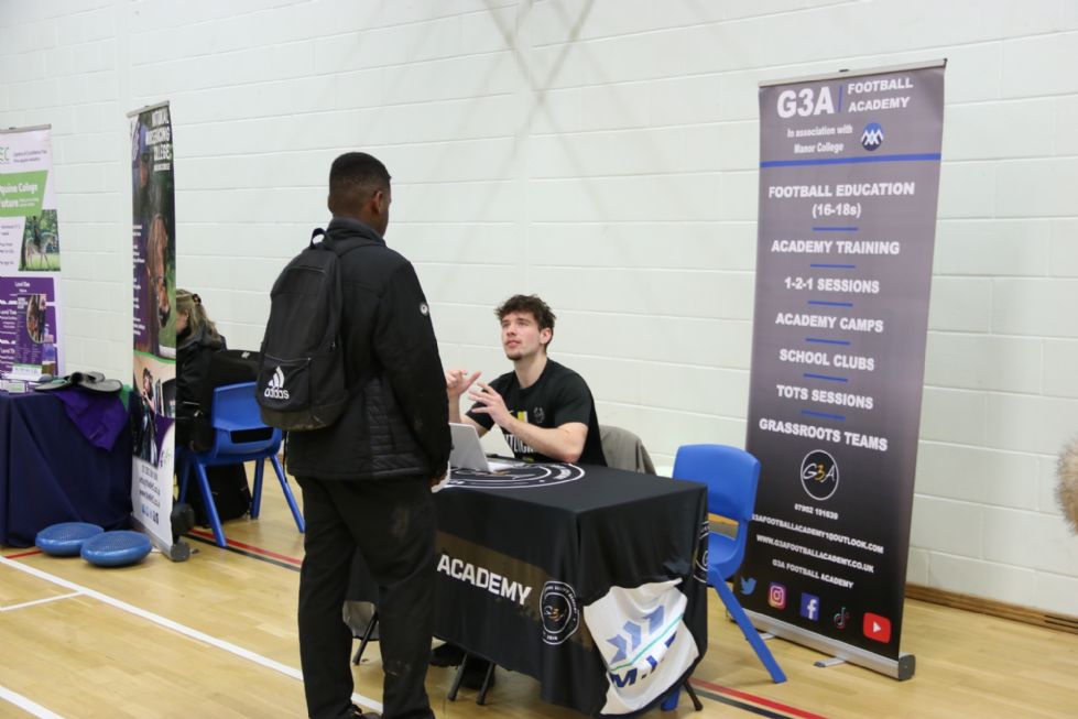 student talks to an employer at the careers fair
