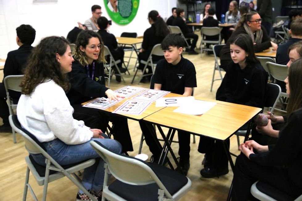 student talks to an employer at the speed networking event