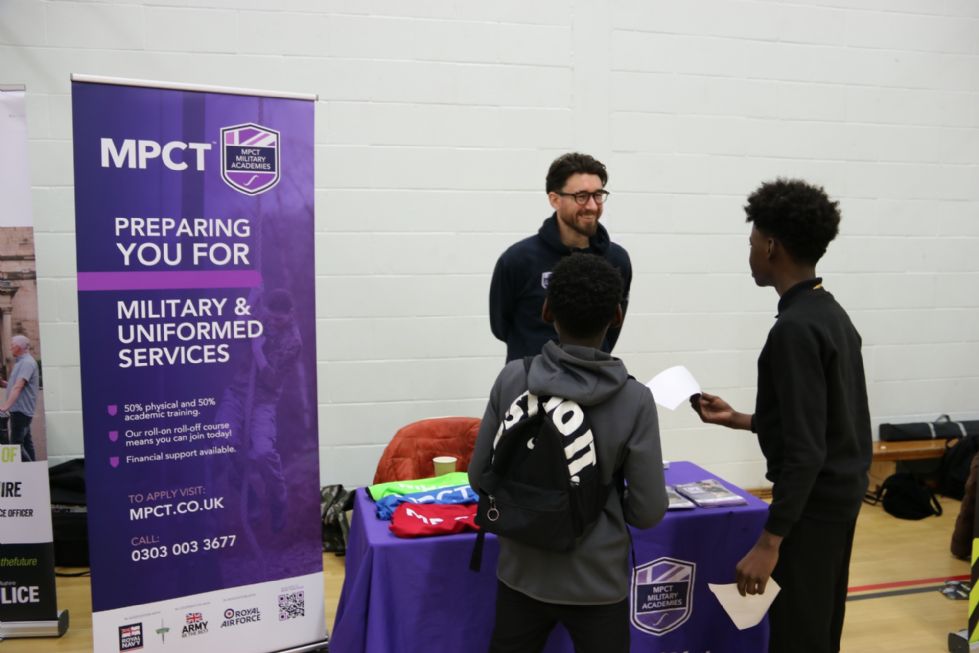 student talks to an employer at the careers fair