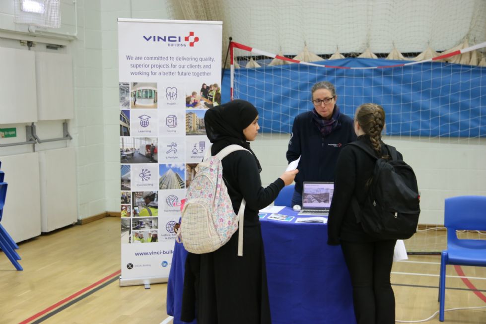student talks to an employer at the careers fair