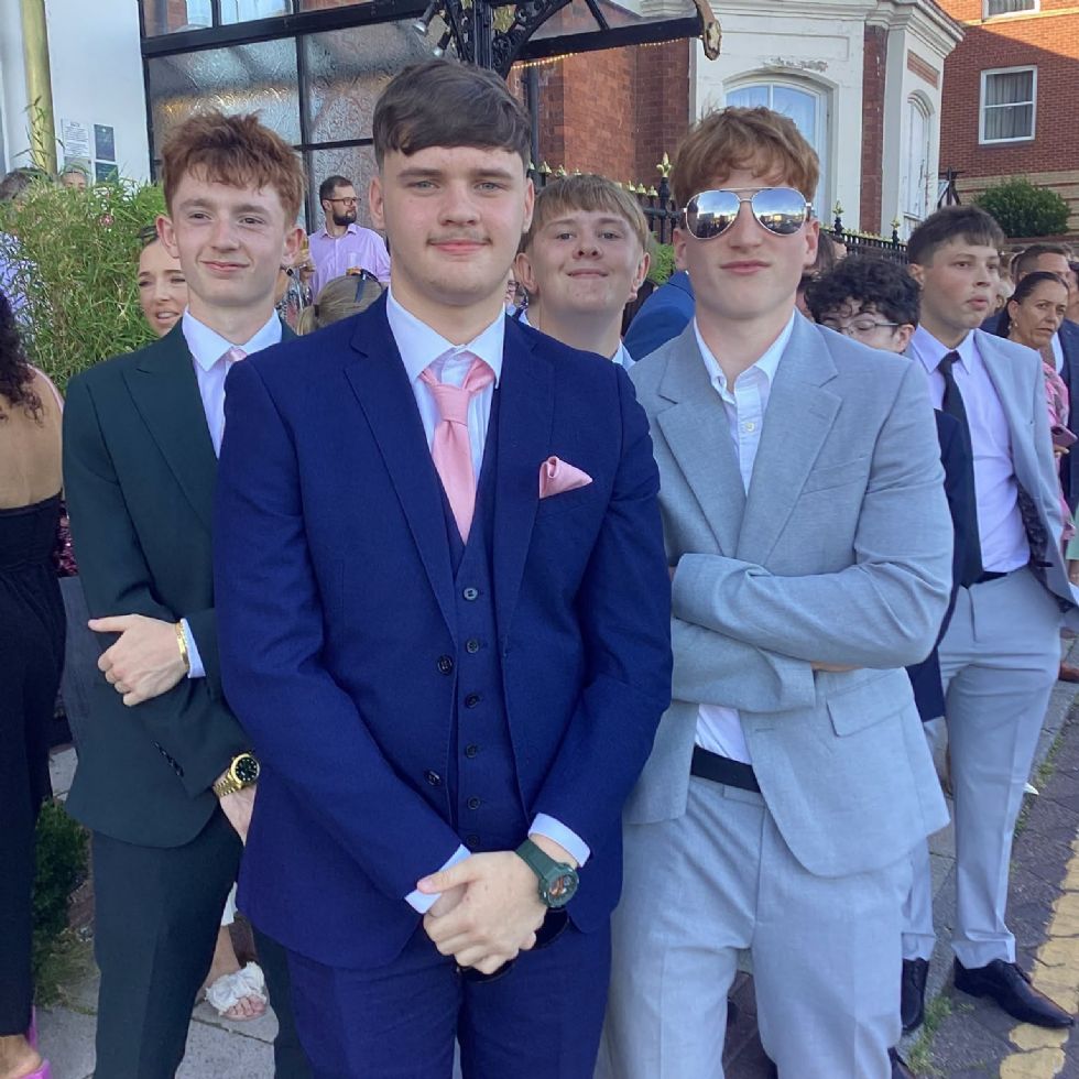 group of boys dressed in suits for prom