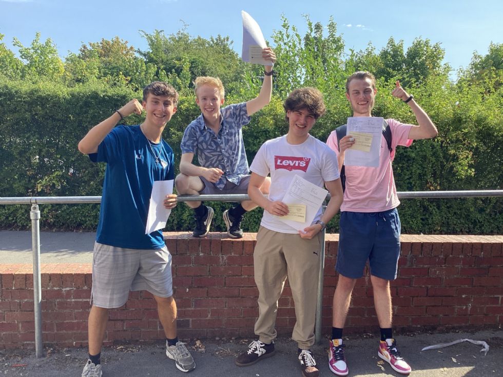 happy sixth form students with their A level results