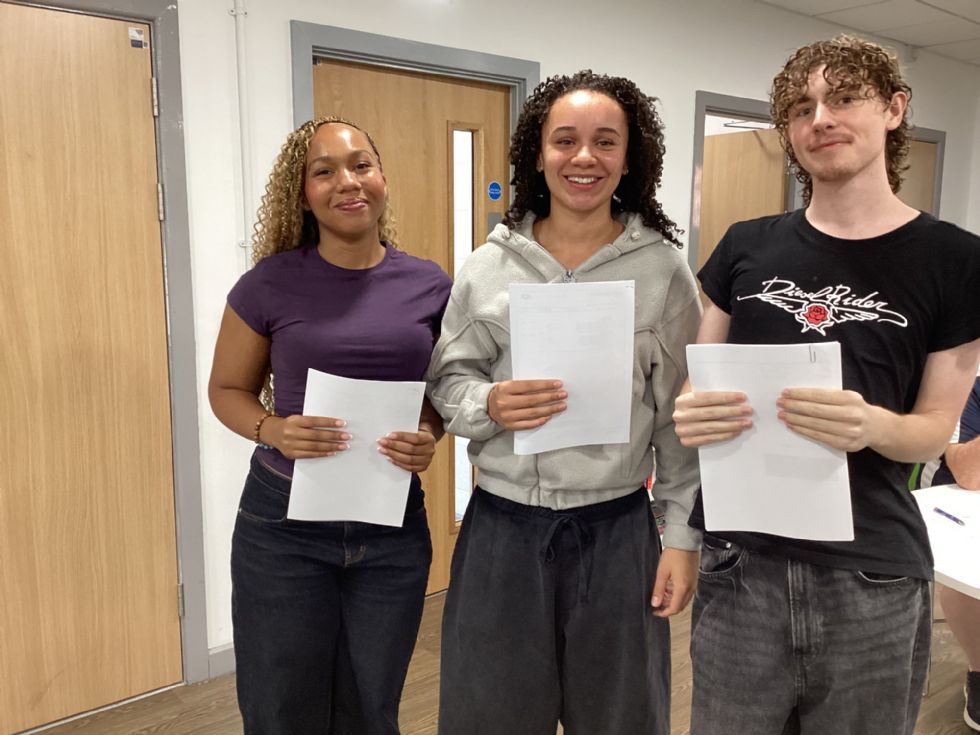 happy sixth form students with their A level results