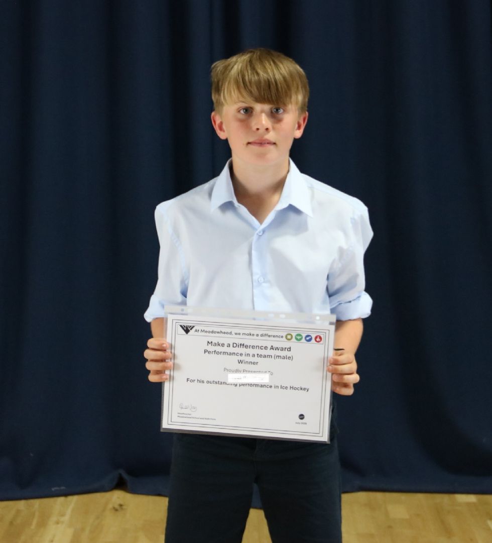 student with their award certificate
