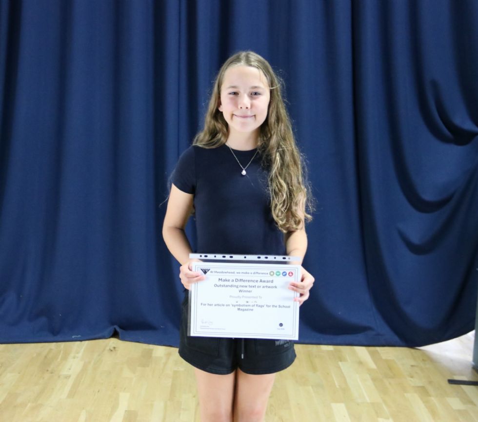 student with their award certificate