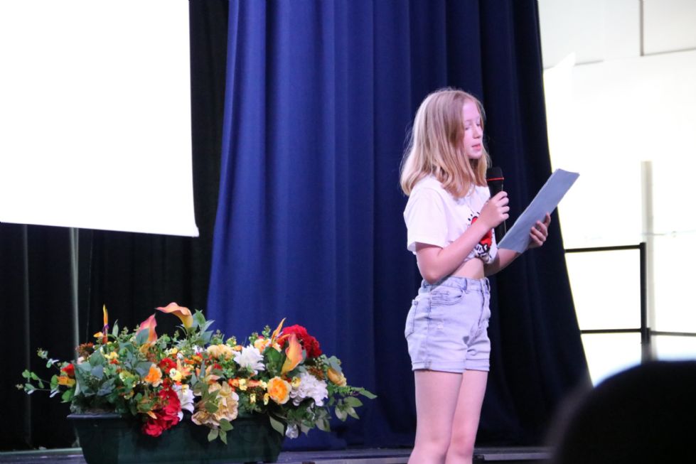 student reading their poem on stage