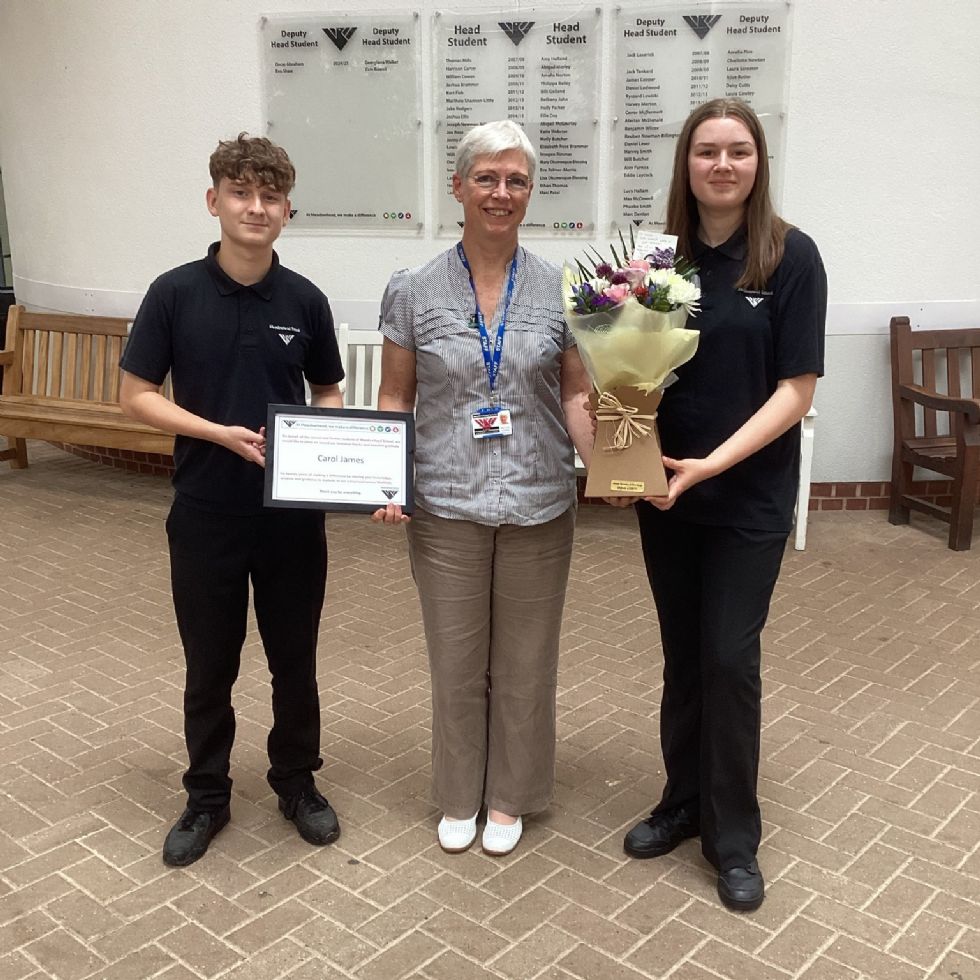 teacher being presented with make a difference award