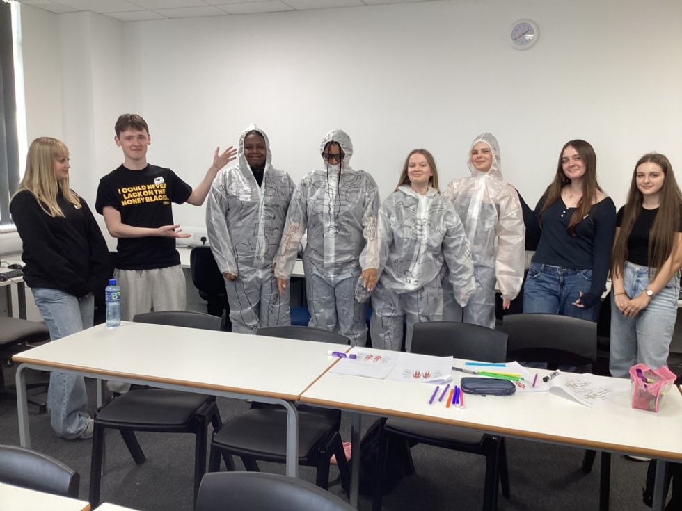 y11 students dressed in hazmat suits for science lesson
