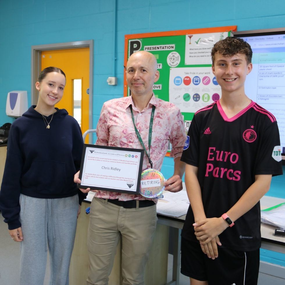 teacher being presented with make a difference award