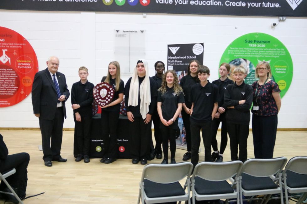 students with the Cook shield, Mr Cook and Ms Woodward