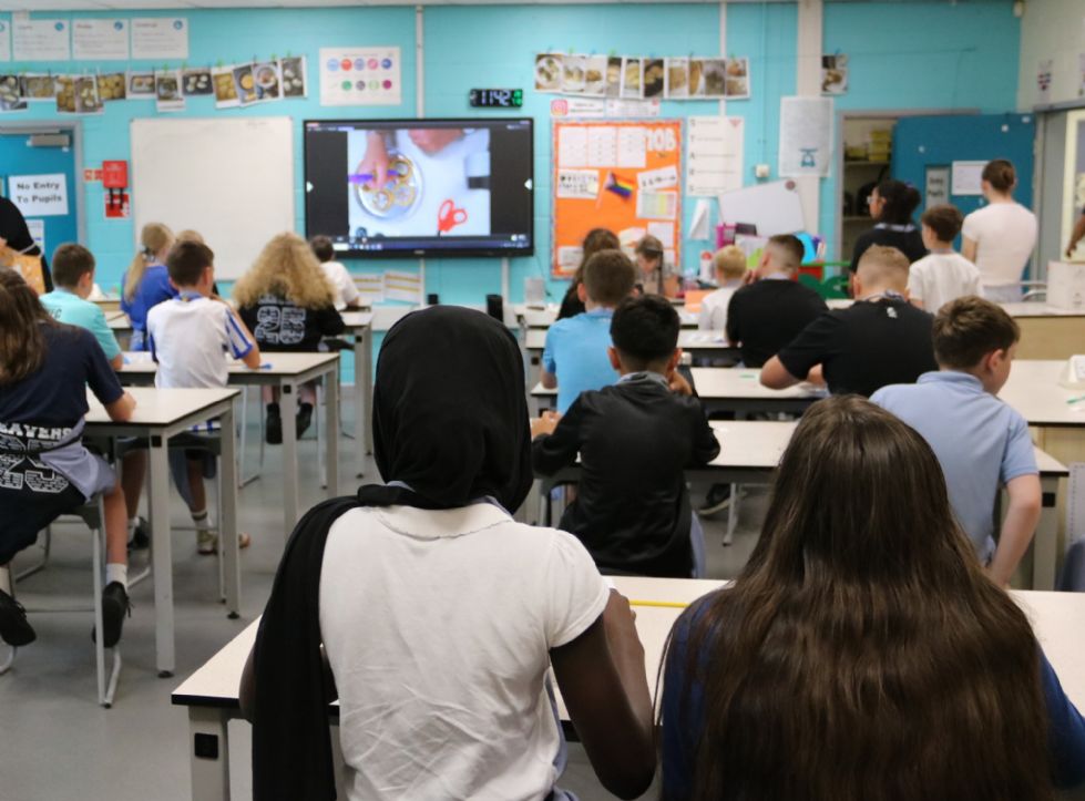 y6 students watching a cookie decoration demo