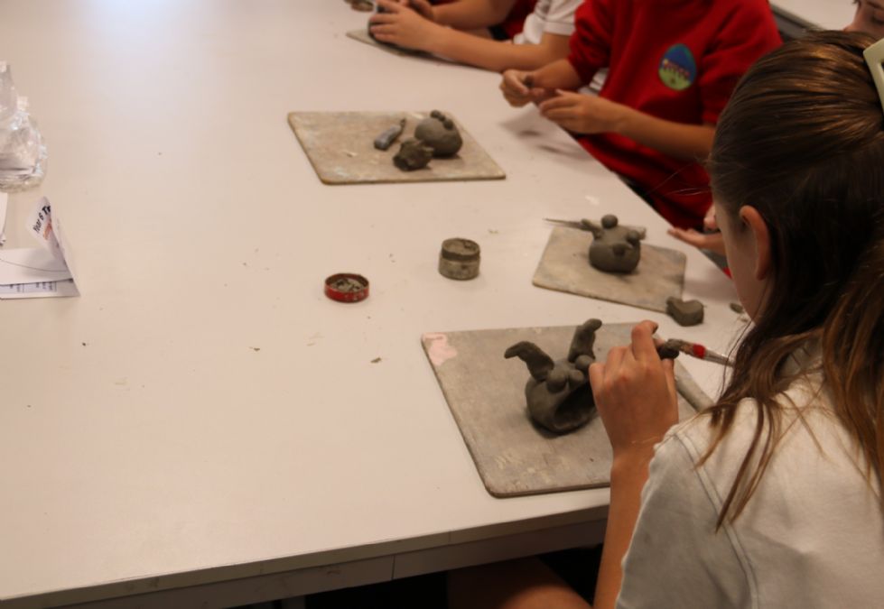 y6 student making a ceramic monster
