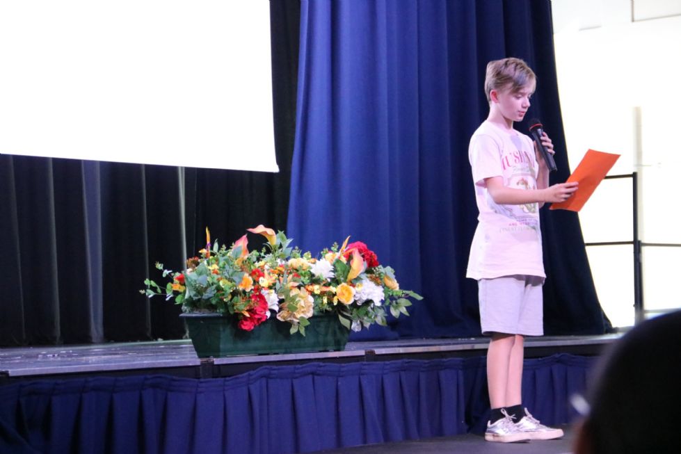 student reading their poem on stage