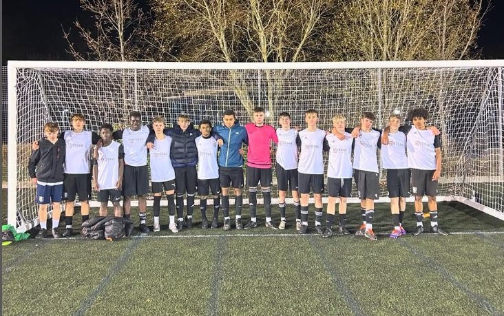 y11 boys football team pose in the goal mouth