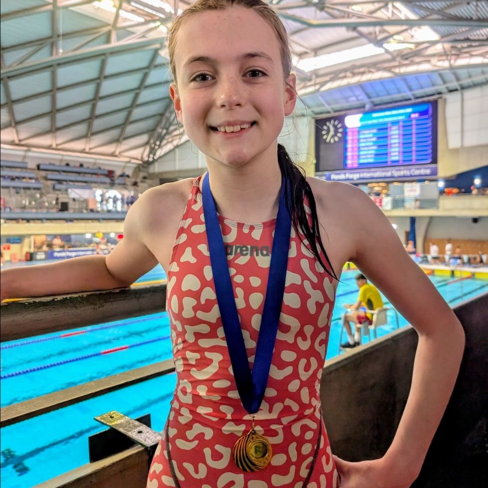 student with medal at a swimming gala