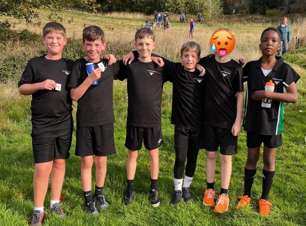 cross country running team pose for photo