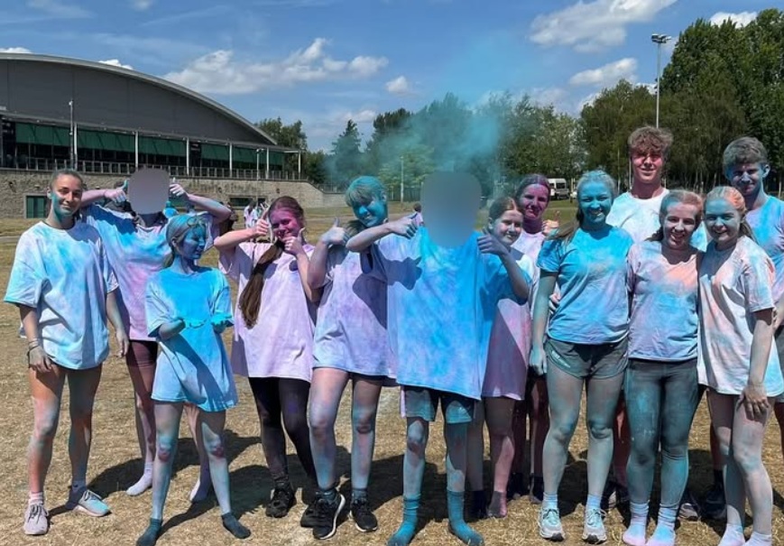 group of students covered in paint at this girl can event