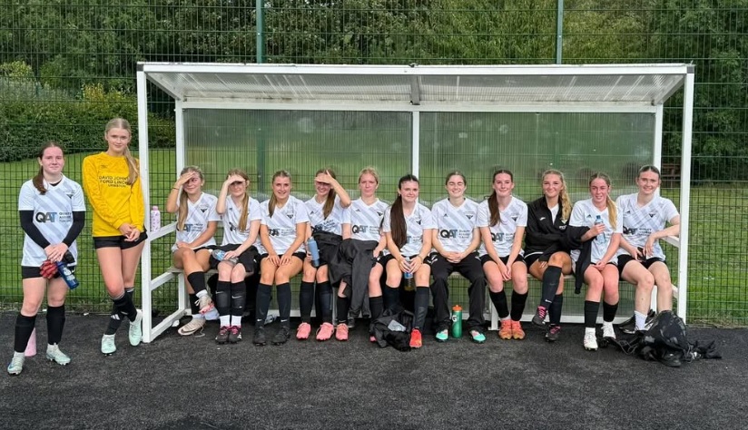 girls football scholarship team pose for a team photo