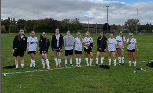 women's scholarship football team pose for photo
