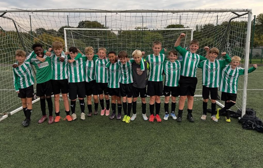 y7 football team pose in goal