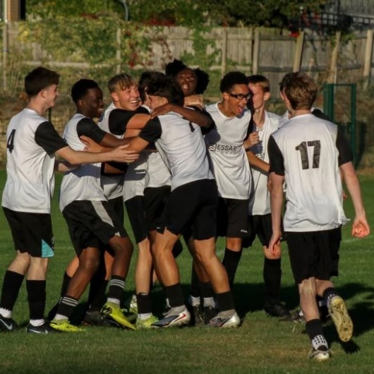 Y11 footballers celebrate their team's victory