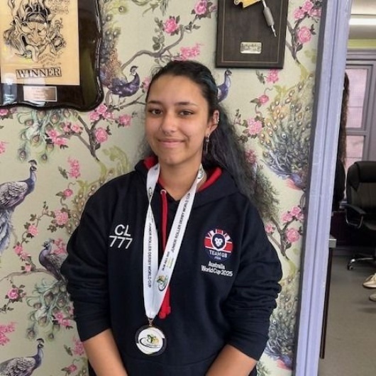 student with her medal for roller derby world cup